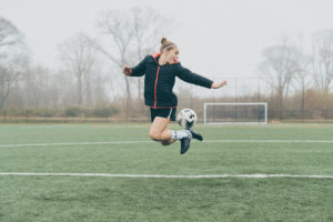 woman doing soccer trick