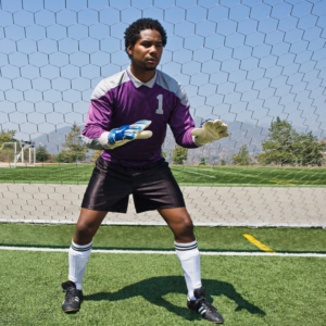 man practicing athletic stance for soccer