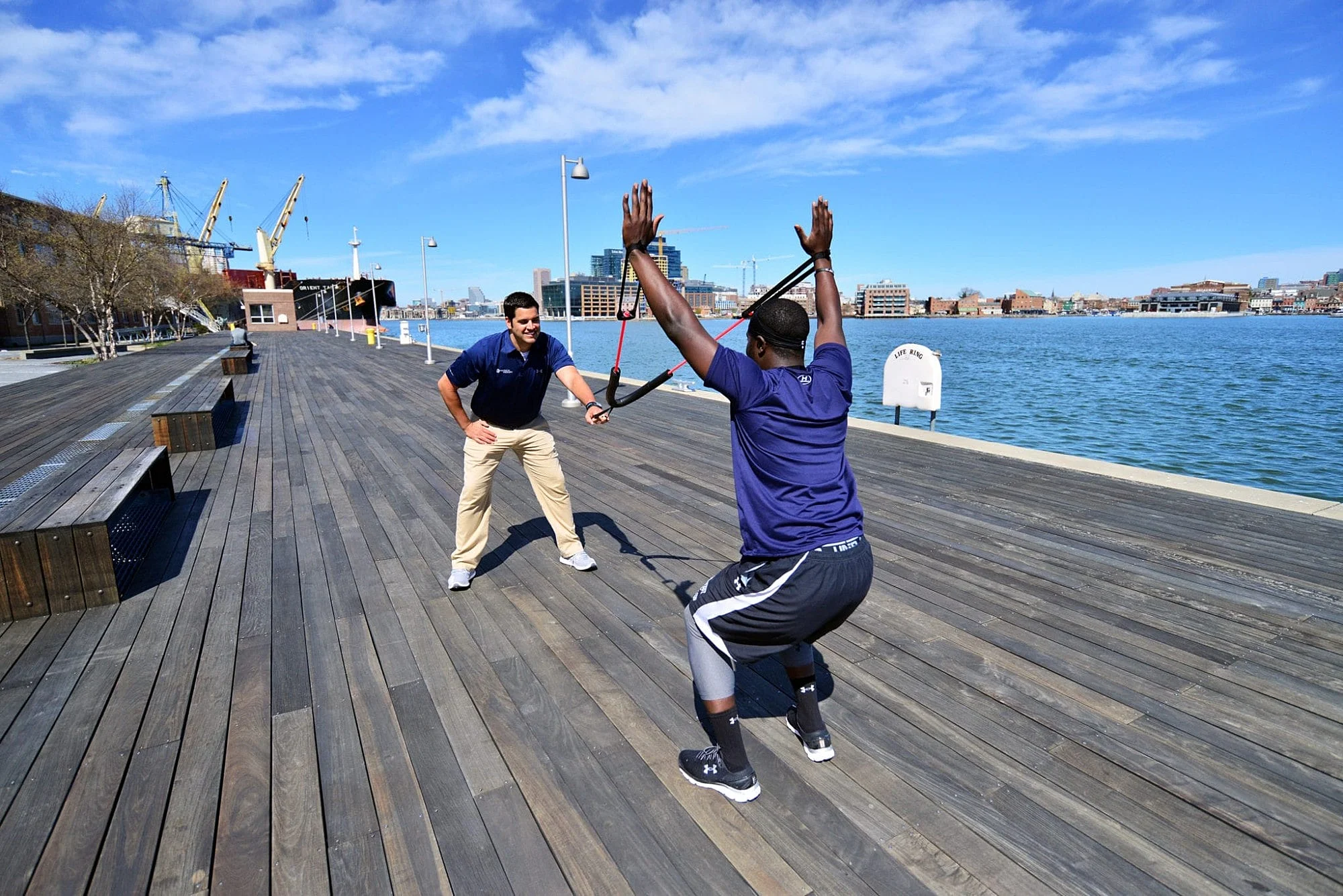Physical Therapist Jarod helping patient do ACL squat